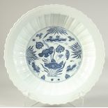 A CHINESE BLUE AND WHITE PETAL FORM LOTUS CHARGER, with ducks and aquatic flora. 41cm diameter.