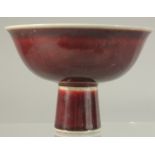 A CHINESE COPPER RED GLAZE PORCELAIN STEM CUP. 15cm diameter.