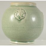 A CHINESE GREEN GLAZE POTTERY VASE with three moulded bosses. 11cm high.