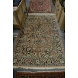 A PERSIAN RUG with floral decoration. 180cm x 120cm.