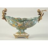 AN OVAL PORCELAIN BOWL with gilt metal cupids. 11ins wide.