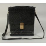 A MADDLER ZURICH BLACK CROCODILE SKIN BAG (USED) 9ins long, 11ins high.