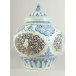 A LARGE CHINESE BLUE, WHITE AND UNDERGLAZE RED PORCELAIN JAR AND COVER, with relief panels depicting