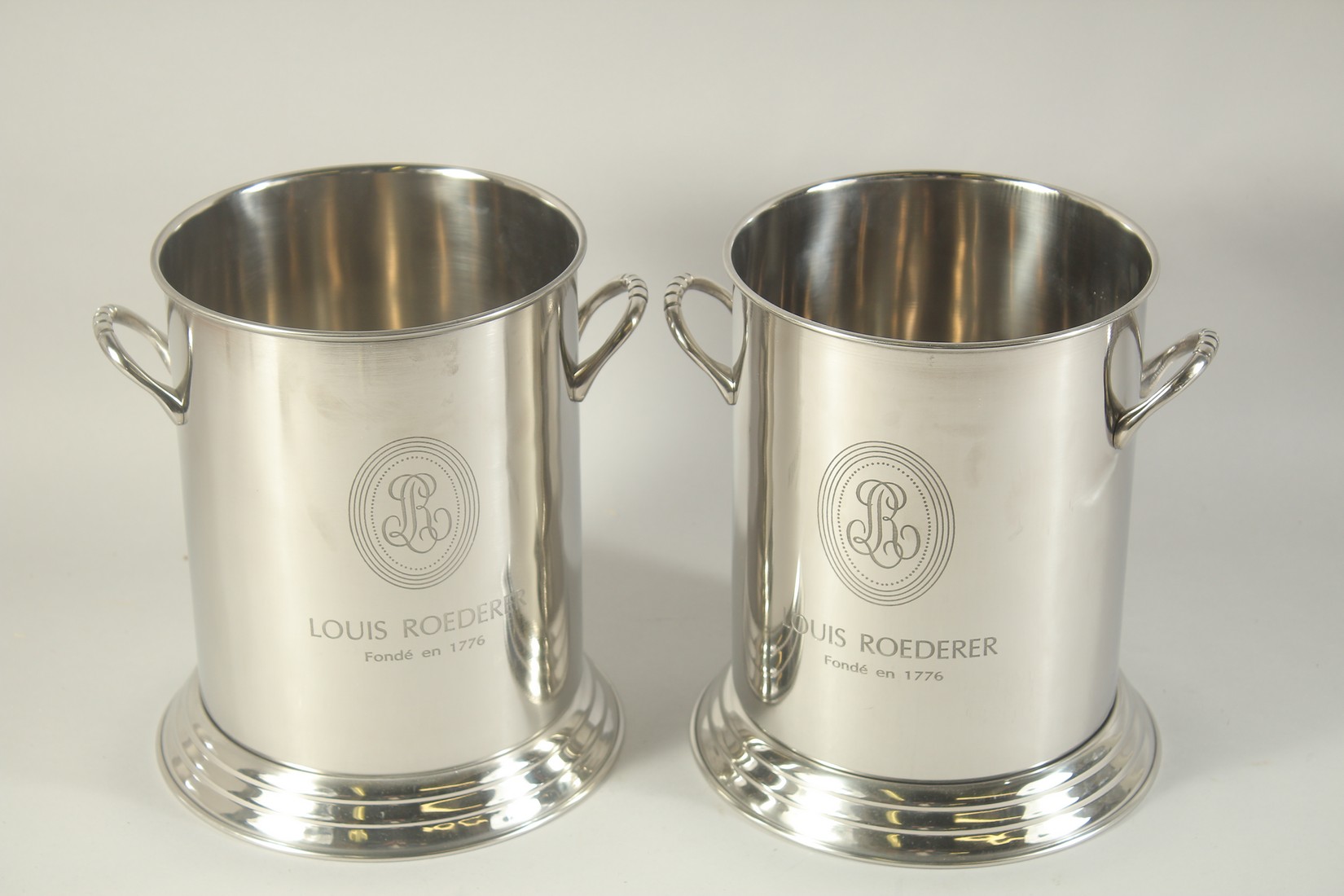 A PAIR OF LOUIS ROEDERER CIRCULAR WINE COOLERS 10ins high.