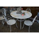 A white painted wrought iron circular garden table and four similar chairs, two with arms.