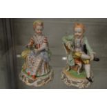 A pair of Dresden porcelain seated figures of a man and women.