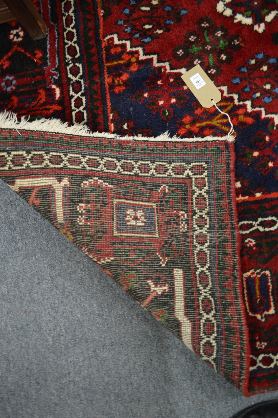 A large Persian design carpet, red ground with stylised decoration, 300cm x 222cm. - Image 2 of 2