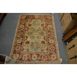 A Persian design rug cream ground with red and blue floral decoration, 148cm x 108cm.