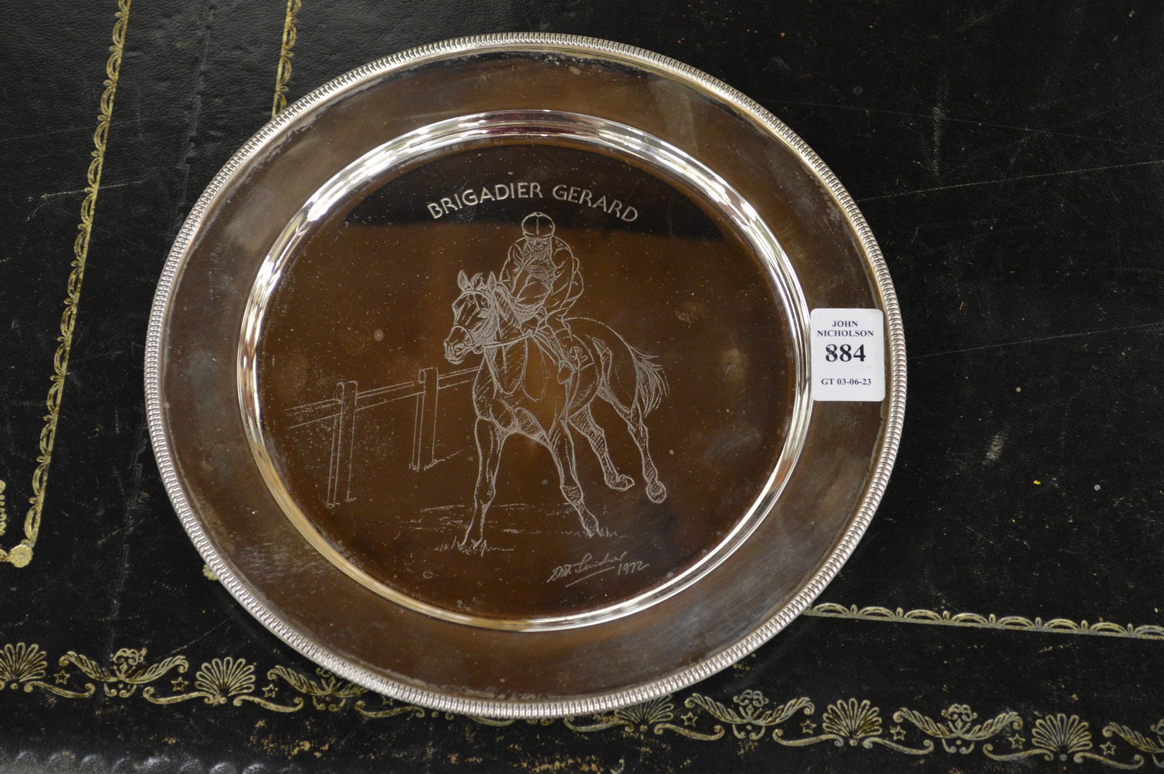 A silver circular equestrian presentation plate.