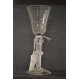 An18th century English wine glass with inverted bell bowl and air twist stem, with knop.