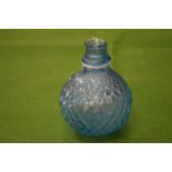 A small moulded blue glass bottle.