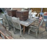 An Alexander Rose rectangular weathered teak garden table with seven chairs, two with arms.