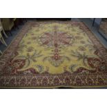 A large Persian style machine made carpet, cream ground with floral decoration, 410cm x 320cm.