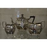 A silver three piece tea service.