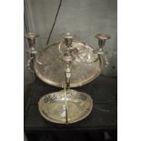 A plated swing handle basket, three light candelabra and twin handled tray.
