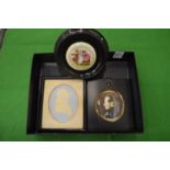 An embossed paper portrait miniature, another miniature and a framed porcelain picture.