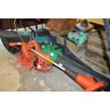 An electric lawn mower, leaf blower and vacuum and a Flymo strimmer.