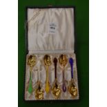 A cased set of six Scandinavian silver gilt and enamel decorated coffee spoons.