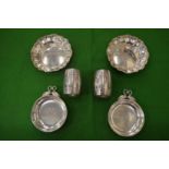 Two pairs of silver dishes and a pair of silver barrel shaped napkin rings.