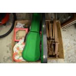 A violin case, old Christmas decorations and quantity of old tennis racket presses.