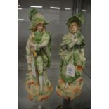 A pair of painted bisque porcelain figures.