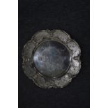 A Stirling silver dish with engraved shaped border.