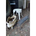 A wrought iron sausage dog, cast iron planter and an aluminium stool.