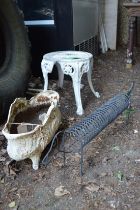A wrought iron sausage dog, cast iron planter and an aluminium stool.