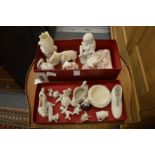 A collection of small white bisque porcelain ornaments and figures.