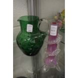 A moulded glass bud vase and a green glass jug.