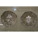 A pair of embossed and pierced silver bon bon dishes.