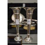 A pair of silver trumpet shaped vases.