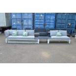 A modern garden lounge suite comprising two stylish sofas, a coffee table together with a green leaf