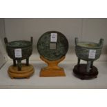 Two Chinese archaic style bronze censers on stands and a similar Bi disc on stand.