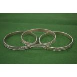 Three engraved silver bangles.