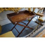 A mahogany butlers tray on folding stand.