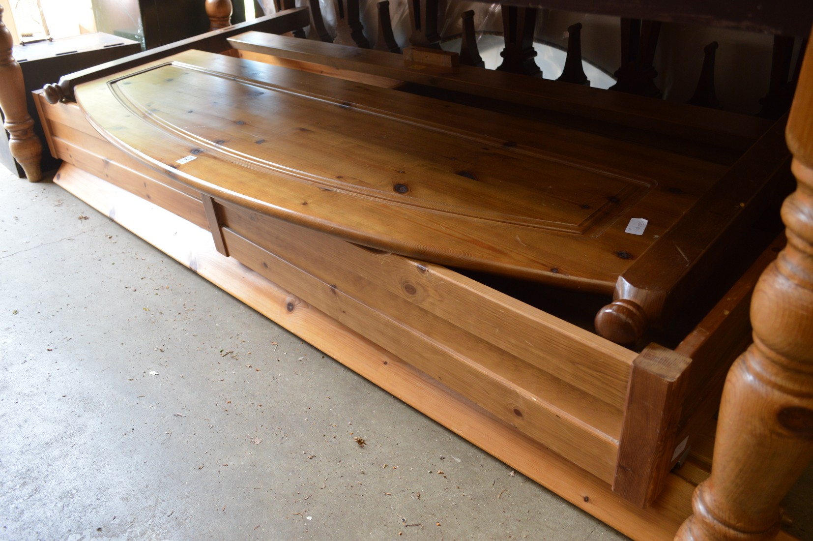 Pine bed frame with underbed storage drawers.