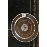 A silver circular equestrian presentation plate.