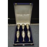 A cased set of nine Asprey & Co silver wine goblets, engraved with initials.