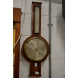 A mahogany cased barometer/thermometer.