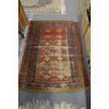 A small Persian rug, worn, 140cm x 97cm.