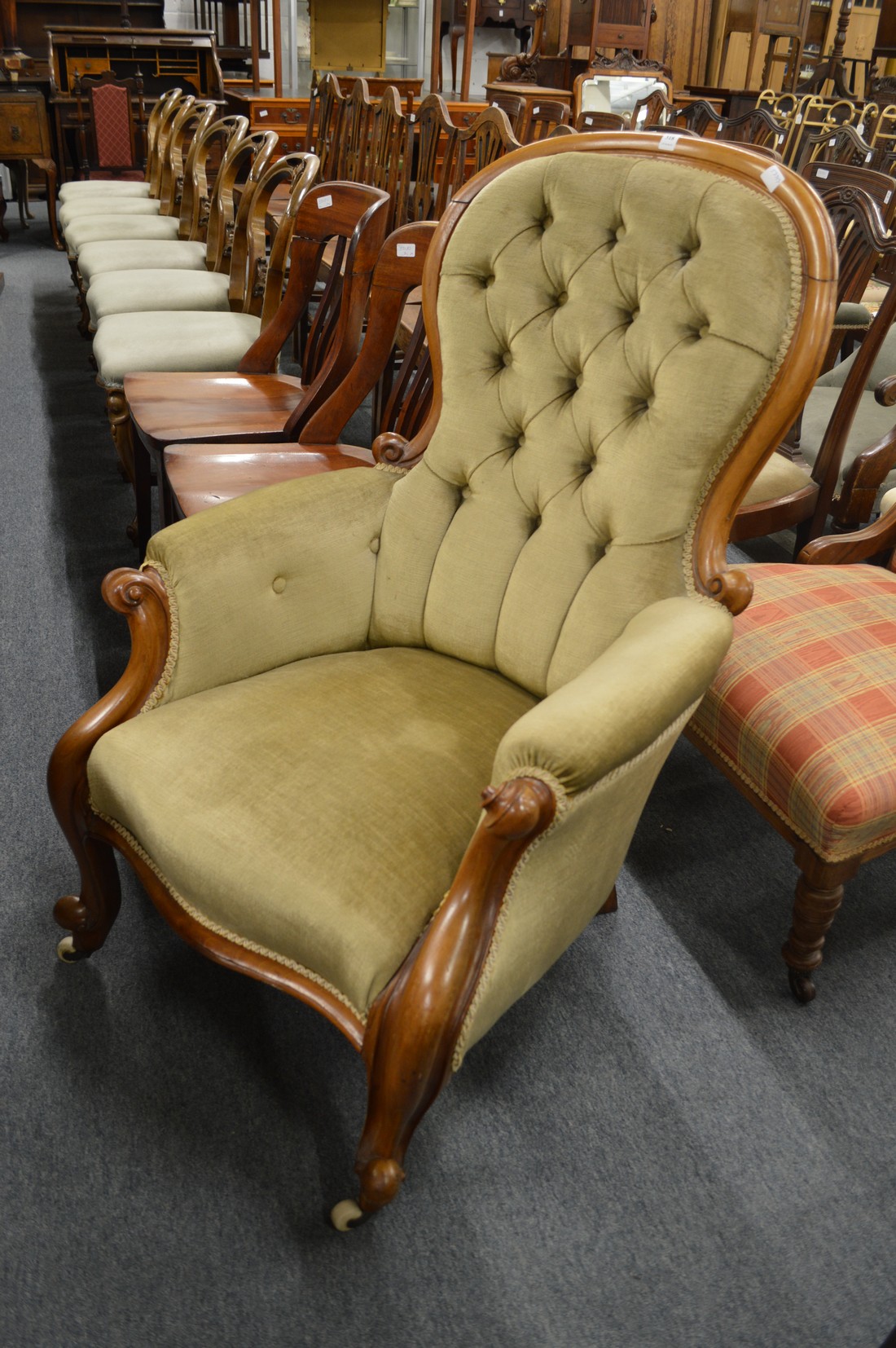 A Victorian button upholstered mahogany framed armchair.