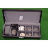 A jewellery box containing various coinage.