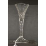 An 18th century English wine glass with tapering bowl.