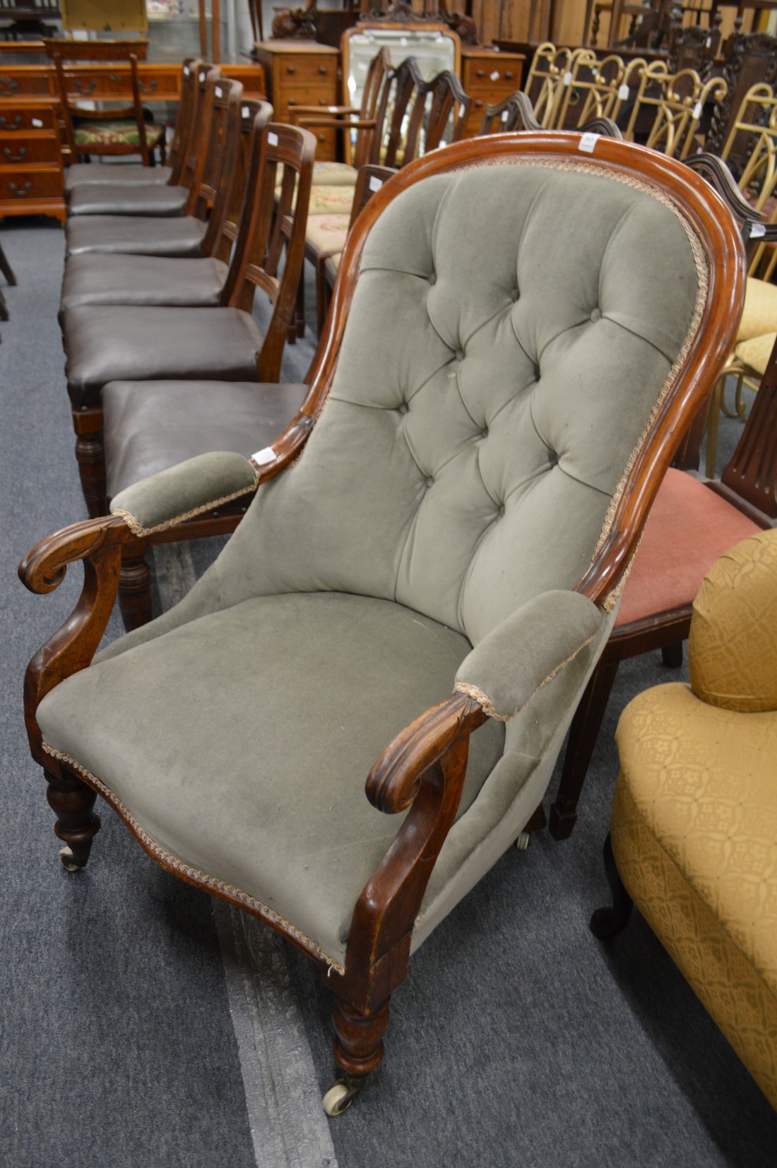 A Victorian button upholstered mahogany framed armchair.