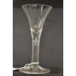 An 18th century English wine glass with tapering bowl.