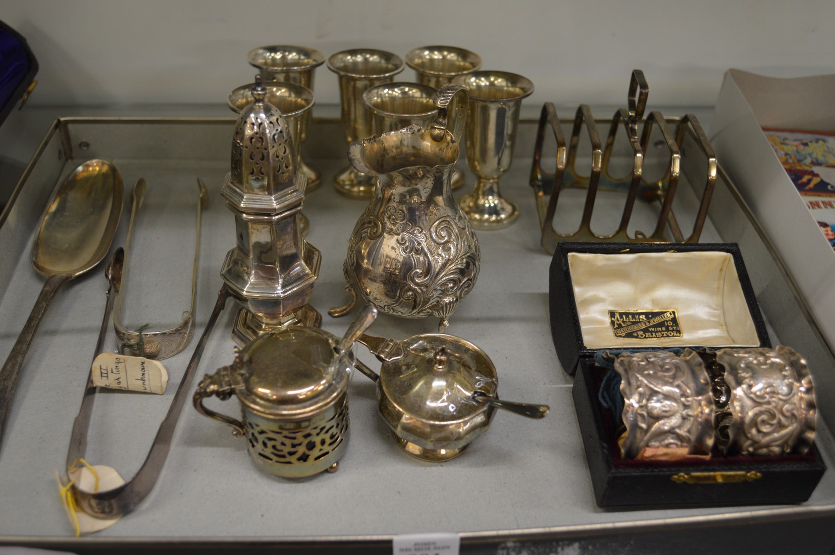 A collection of mixed silver items to include pedestal cups, pair of cased napkin rings, cream jug