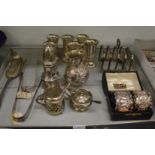 A collection of mixed silver items to include pedestal cups, pair of cased napkin rings, cream jug
