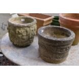Two reconstituted stone circular plant pots.