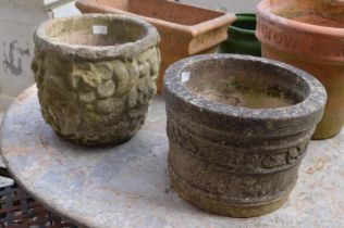 Two reconstituted stone circular plant pots.